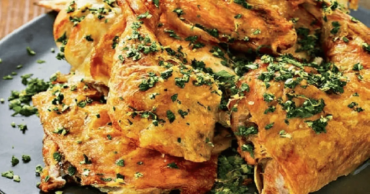 Chicken cooked flat under a brick with deeply crisped golden skin, finished with herb gremolata