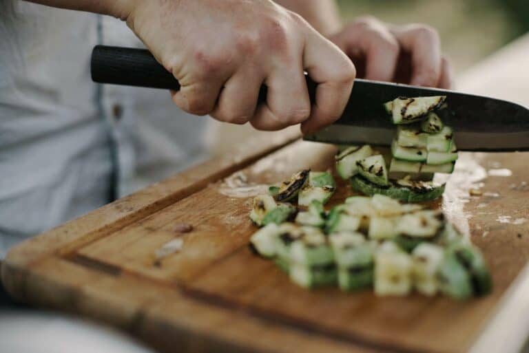 man cutting vegetable with knife