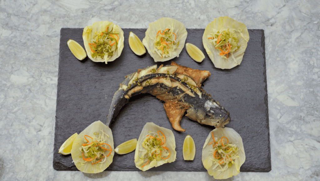 Gordon unravels the complexities of cooking with whole fish. Discover how to trim, marinate, and shallow-fry an entire branzino. The impressive presentation invites guests to engage and assemble their own Thai chili lettuce cups.