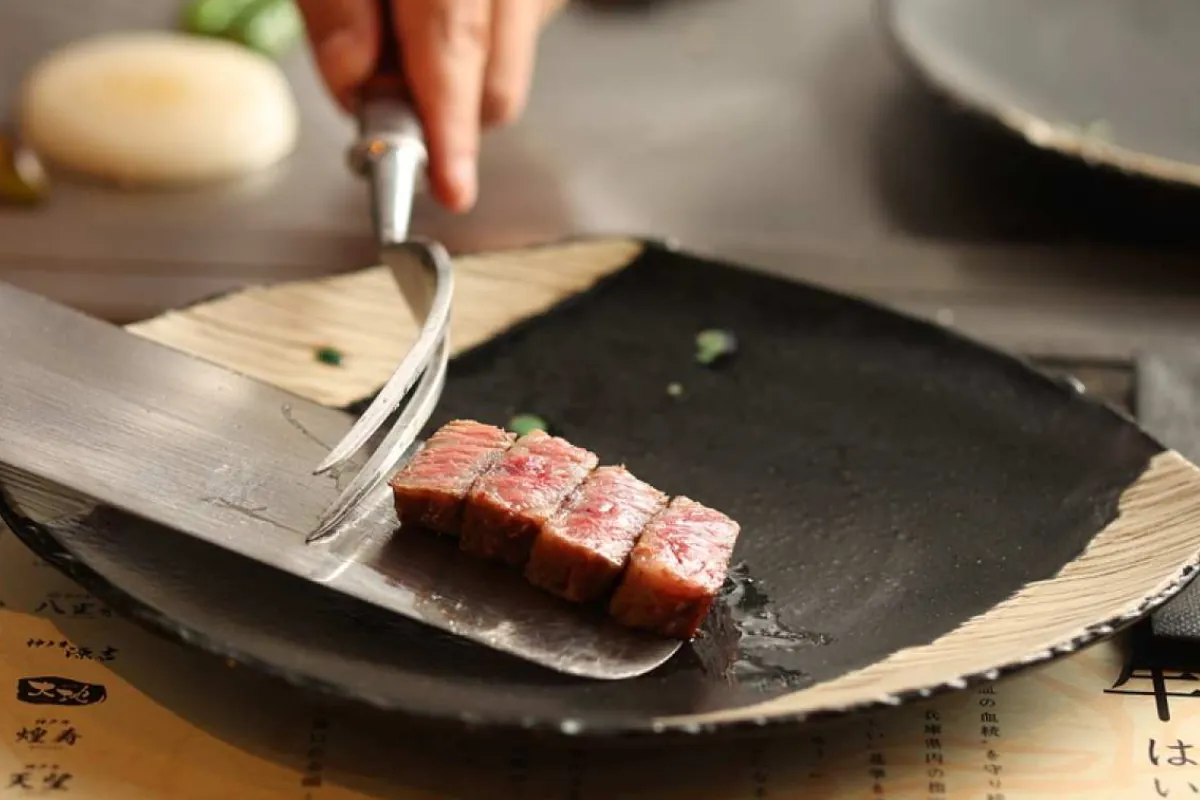 A restaurant menu snippet with a questionable “Kobe” label highlighted, the kind of loose naming that usually means American Wagyu rather than real Kobe