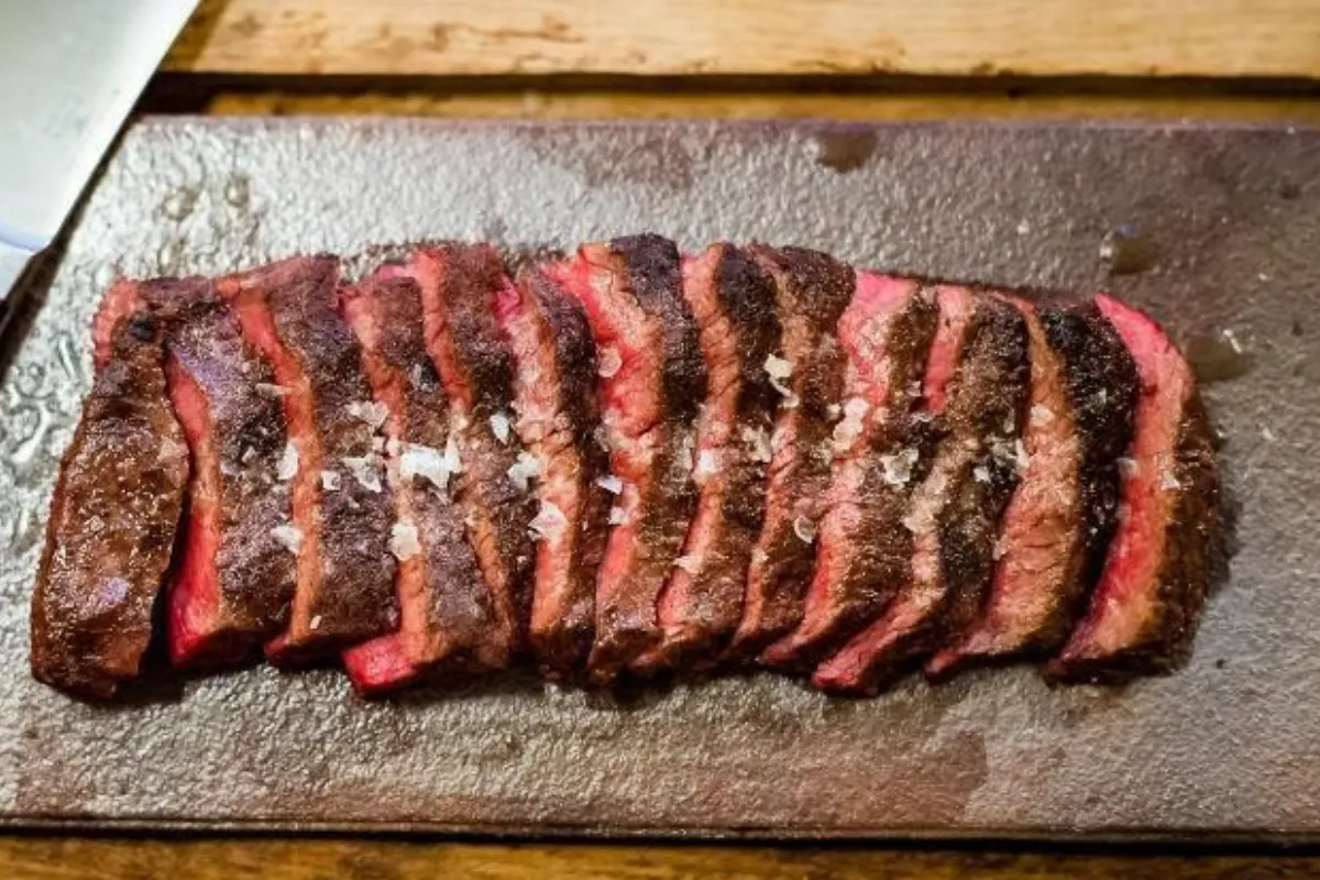 Close-up of a seared Japanese Wagyu ribeye with dense, fine white marbling threaded through the deep red meat